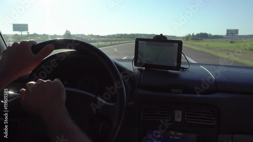 GPS navigation in car with man driving 4K. Close up on navigation screen showing road to follow. Smartphone navigation device.