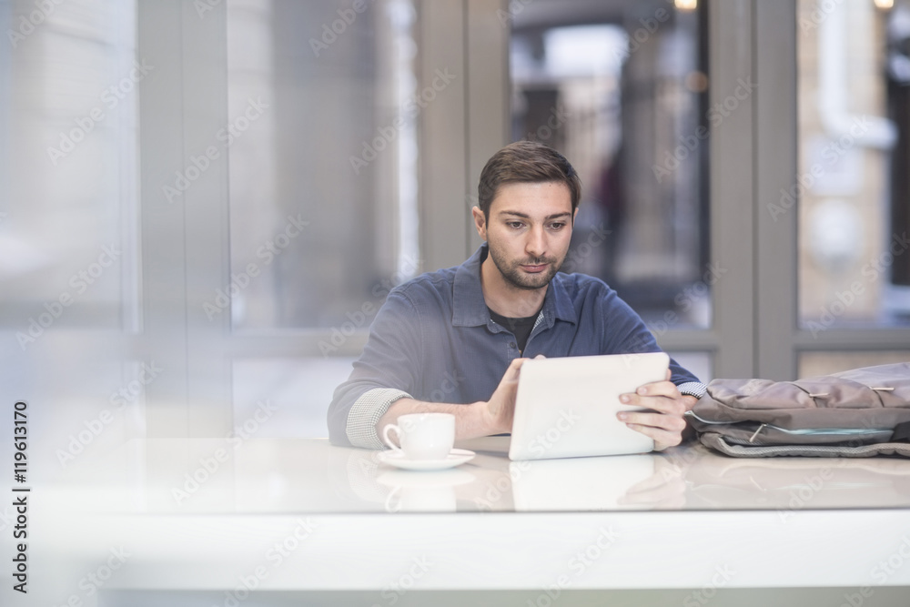 Man using digital tablet at office desk Man using digital tablet at office desk