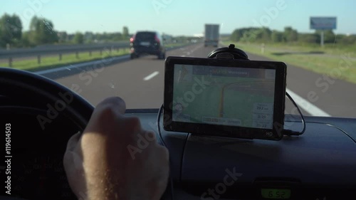 GPS navigation in car with man driving 4K. Close up on navigation screen showing road to follow. Smartphone navigation device.