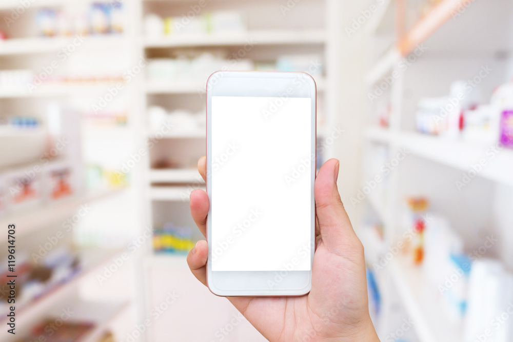 Woman using mobile smartphone in the pharmacy Woman using mobile smartphone in the pharmacy