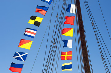Fotobehang Zeilen Kleurrijke nautische vlaggen in wind  © lazyllama