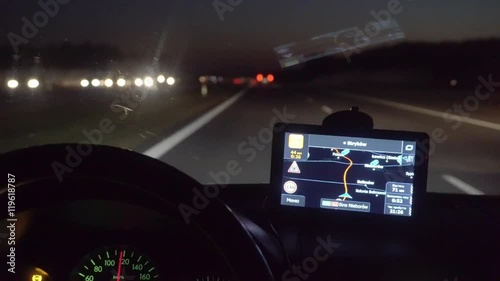 A man driving a car on the overpass turning. Inside view. Evening-night time, real time capture. Wide angle