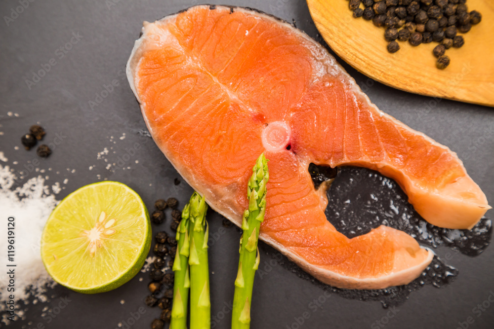 Salmon fillet on flat black rocks with lime chilli tomato salt a Salmon fillet on flat black rocks with lime chilli tomato salt a
