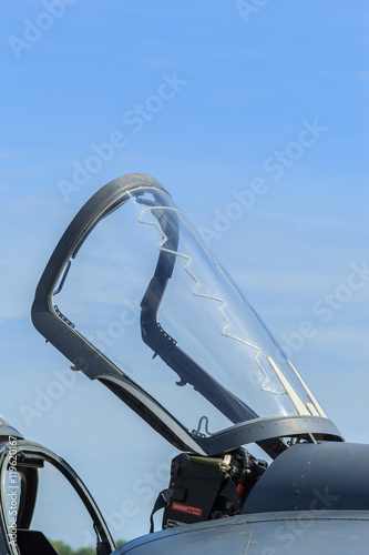 Closeup of aircraft canopy against a blue sky