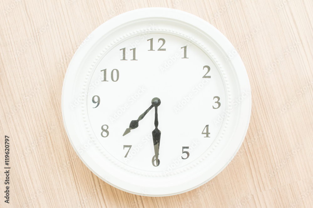 White clock on wood wall White clock on wood wall