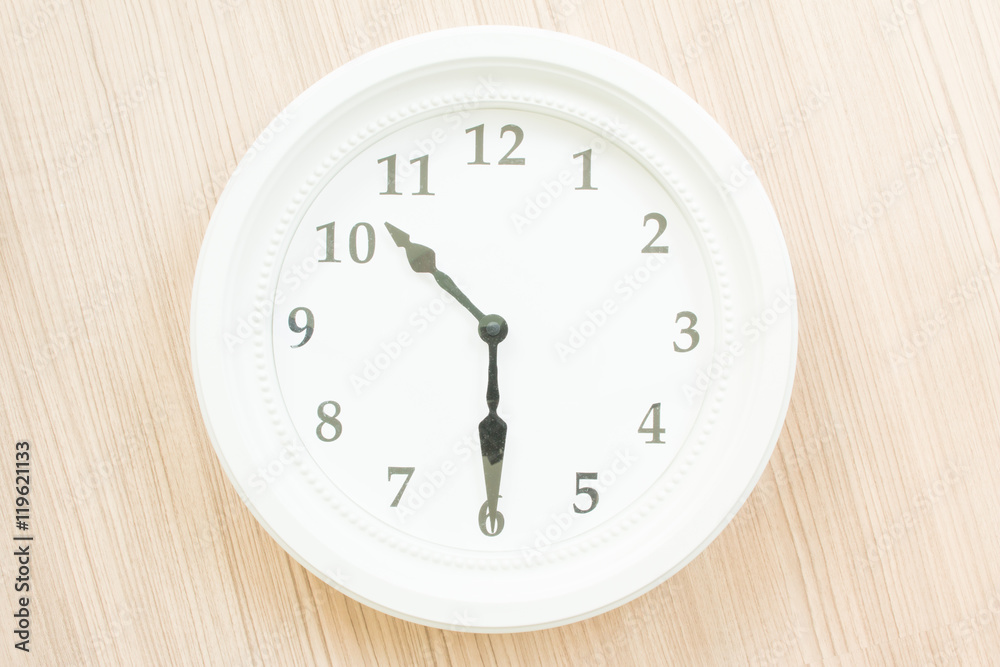 White clock on wood wall White clock on wood wall