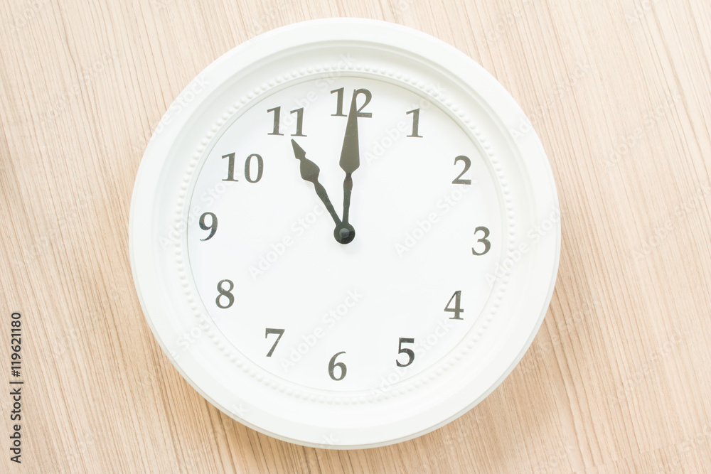 White clock on wood wall White clock on wood wall