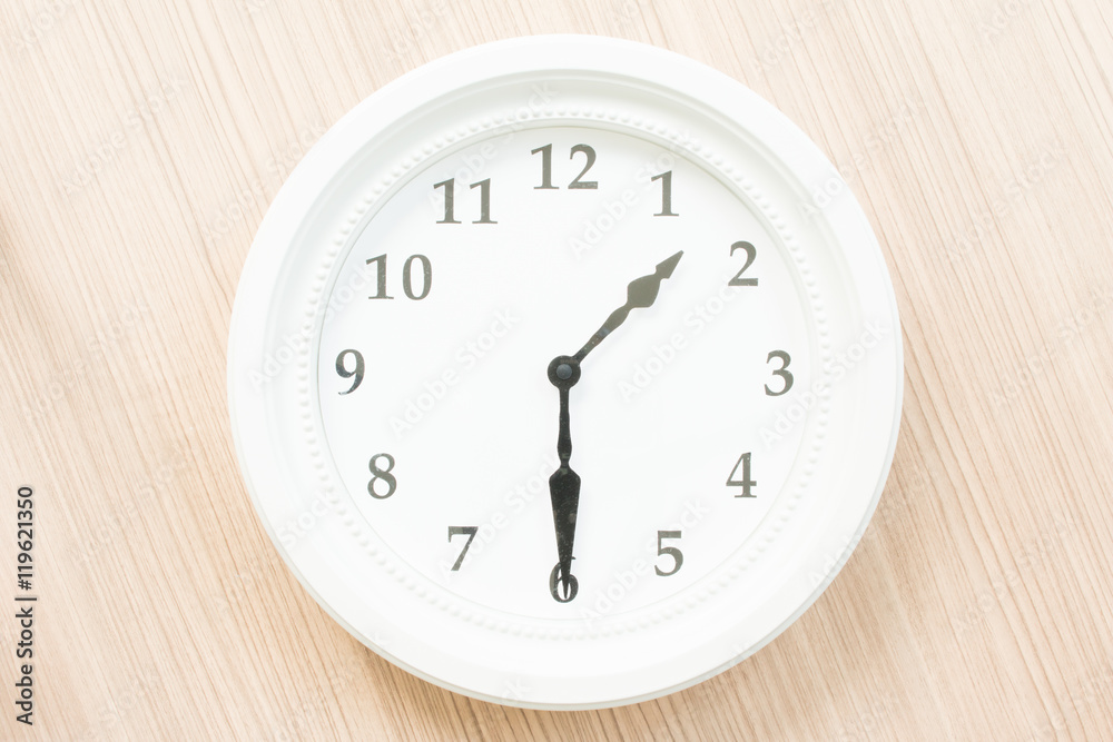 White clock on wood wall White clock on wood wall