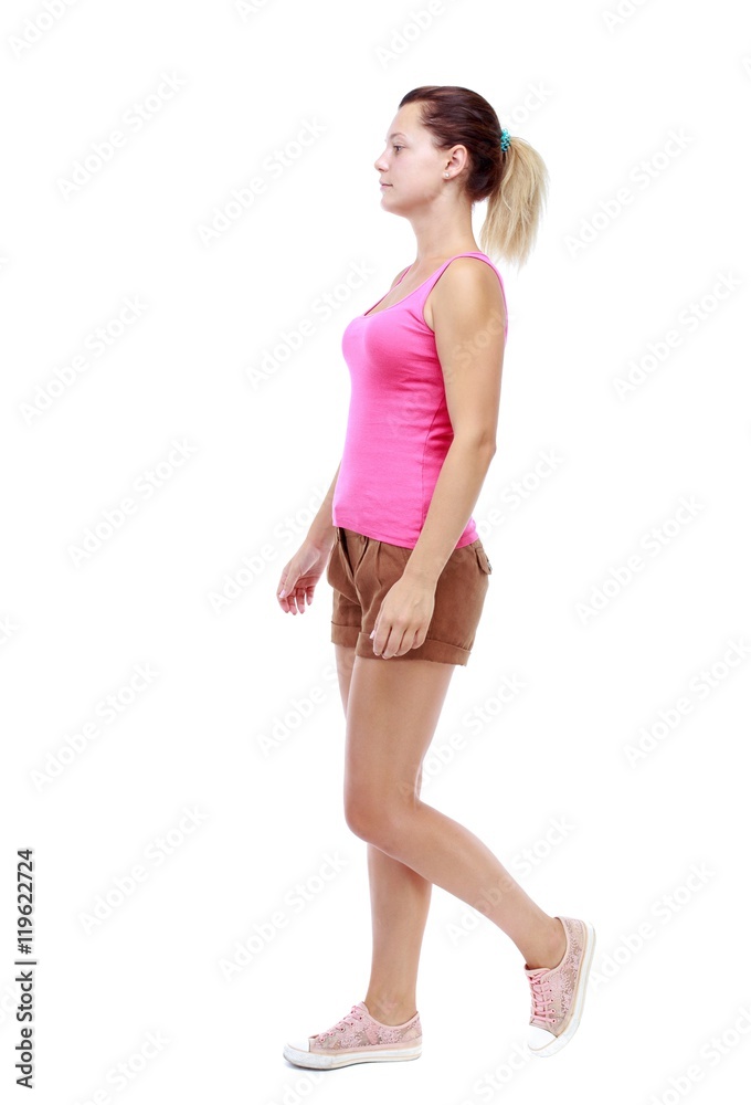 back view of walking woman. beautiful girl in motion. Isolated over white background. Sport blond in brown shorts out sideways. back view of walking woman. beautiful girl in motion. Isolated over white background. Sport blond in brown shorts out sideways.