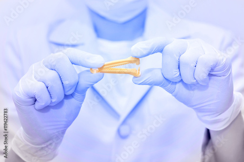 Yellow umbilical cord clamp used to clamp off the umbilical cord