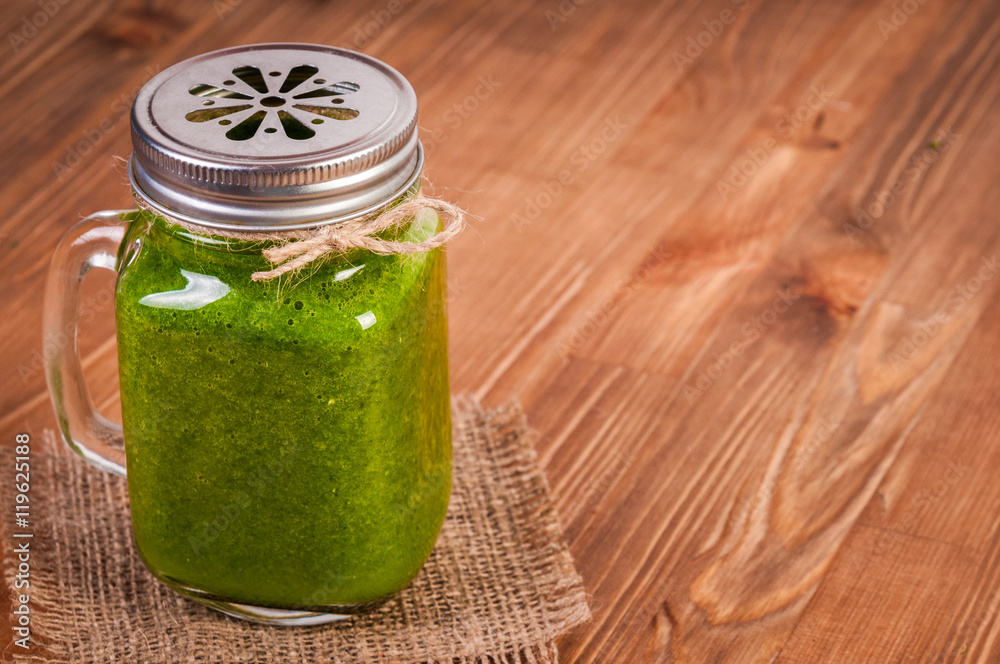 Jar mugs filled with green fresh organic spinach and lime lemon smoothie. Detox concept. Jar mugs filled with green fresh organic spinach and lime lemon smoothie. Detox concept.
