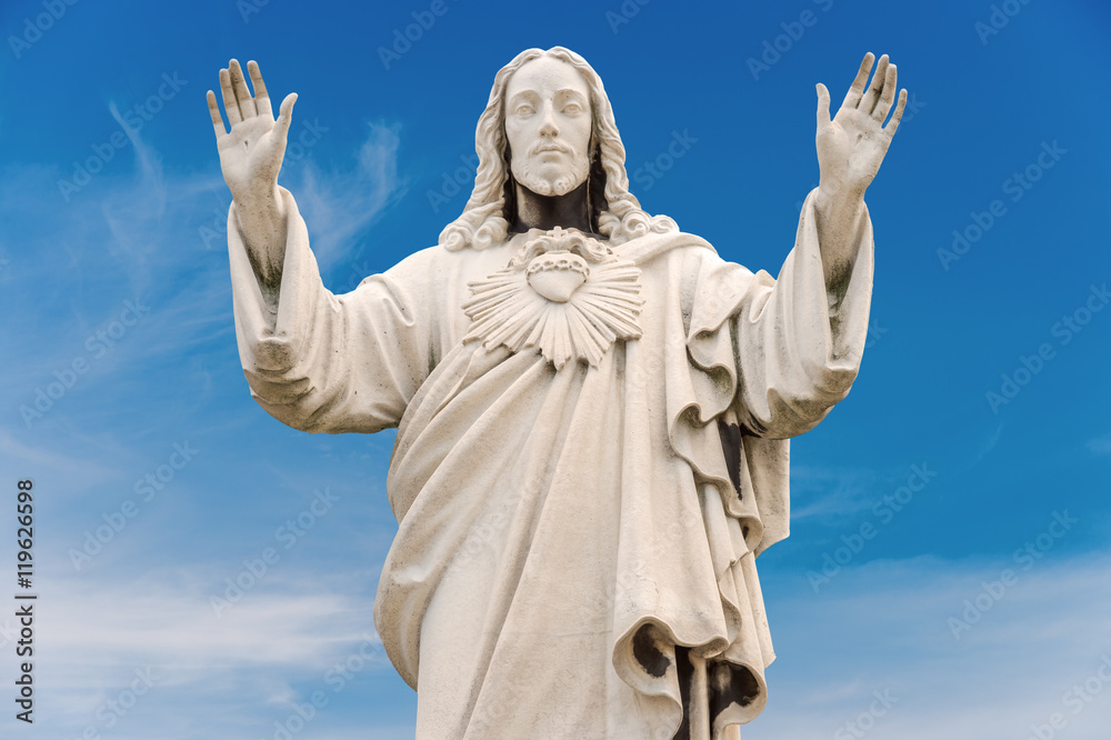 Old Jesus Christ Statue isolated over blue sky Old Jesus Christ Statue isolated over blue sky