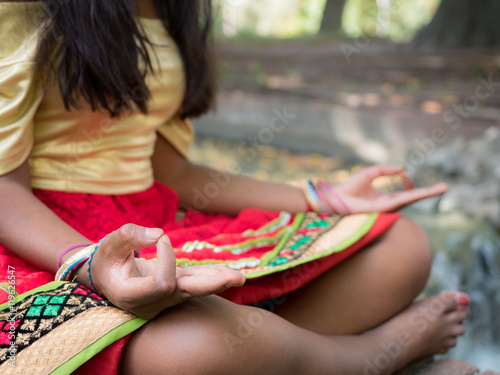 Hindu woman meditating in the park