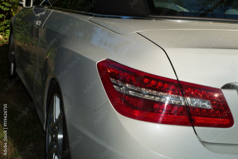 Back of a white beautiful car, red bumper