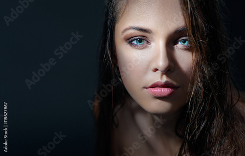 Sexy model with beautiful blue eyes. Close up studio portrait.