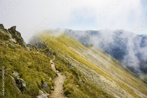 Mountain peaks in the clouds in Fagaras, Carpathian Mountains, Romania