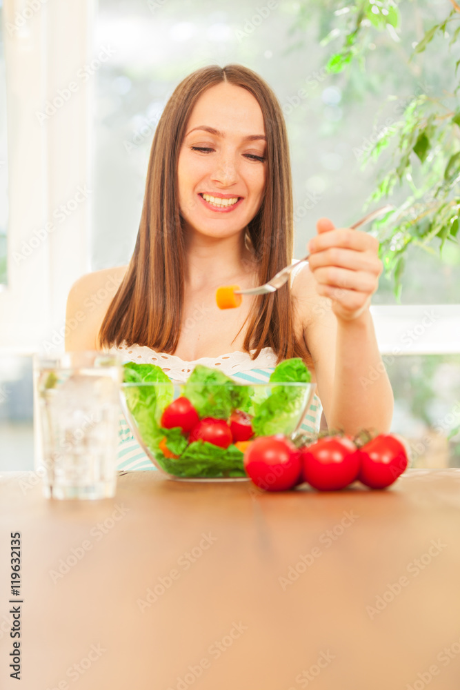Woman is eating salad