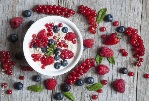 Tablou pe pânză Yogurt with fresh berries in a white bowl