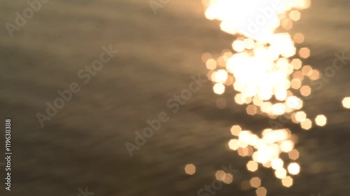 Sunlight glistens on the ocean at sunset