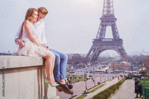 romantic love, affectionate couple sitting near Eiffel Tower in Paris, honeymoon in Europe