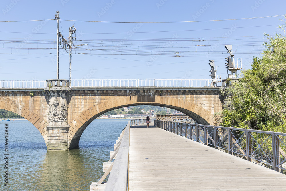 Obraz premium riverside walkway and railway border bridge in Hendaye in the French Basque Country, France 
