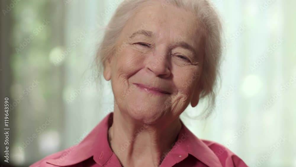 Close up of a happy elderly senior woman smiling. Shot in 4K UHD.