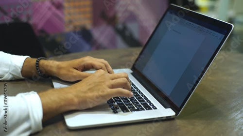 Closeup of businessman typing on laptop computer