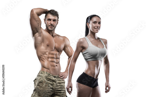 Sports man and woman posing in studio