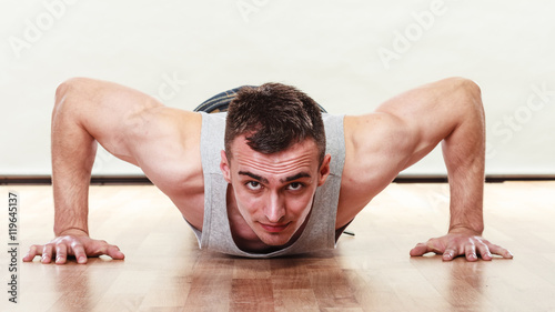 Sports man making pushups,