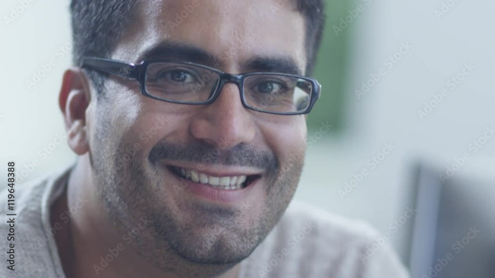Portrait of Young Smiling Man in Glasses. Shot on RED Cinema Camera in 4K (UHD). Portrait of Young Smiling Man in Glasses. Shot on RED Cinema Camera in 4K (UHD).