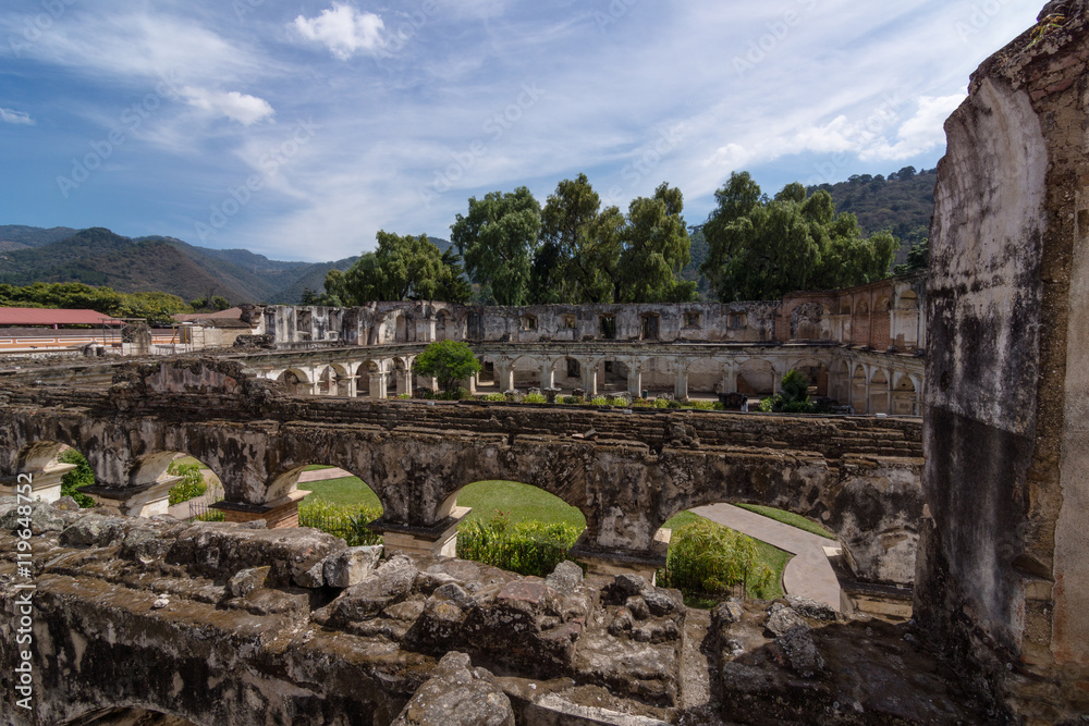 Looking out from the two levels of arches onto the cloister of Iglesia y Convento de Santa Clara in Antigua Guatemala (Guatemala)