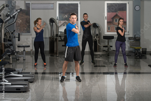 People Stretching During Fitness Class In Fitness Center