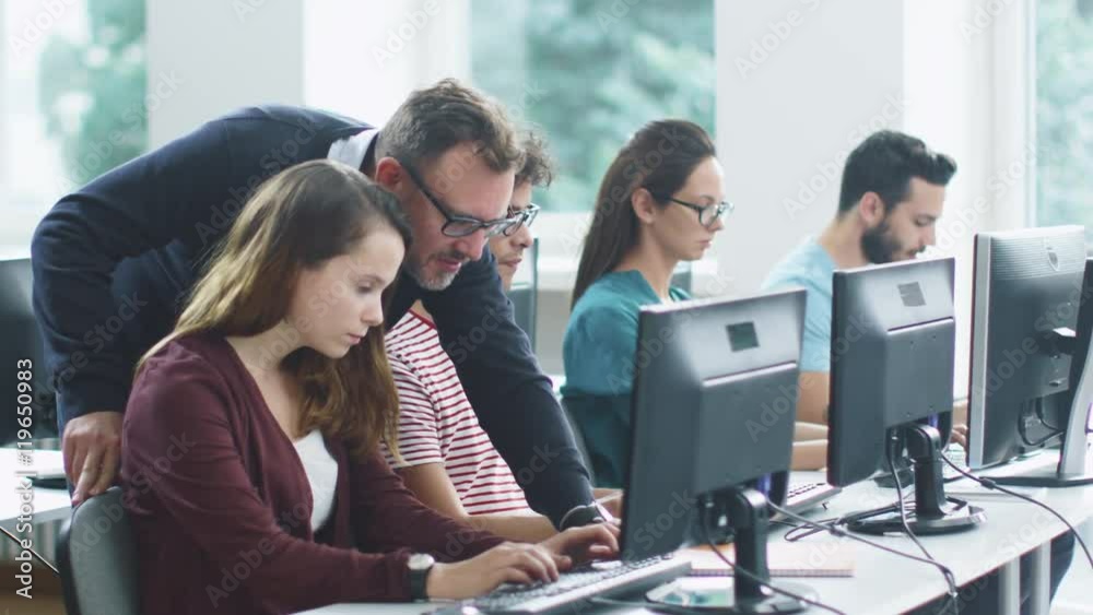 Teacher Helps Students in Computer Class During Lecture. Shot on RED ...