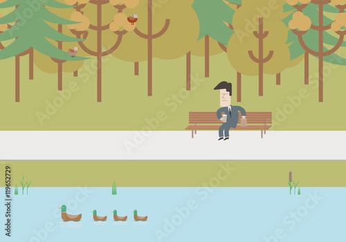 Businessman on a bench at lunchtime