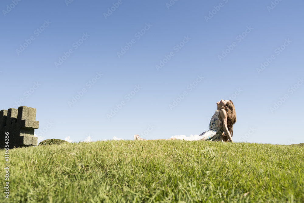 Young women are relaxing on the lawn of the park Young women are relaxing on the lawn of the park