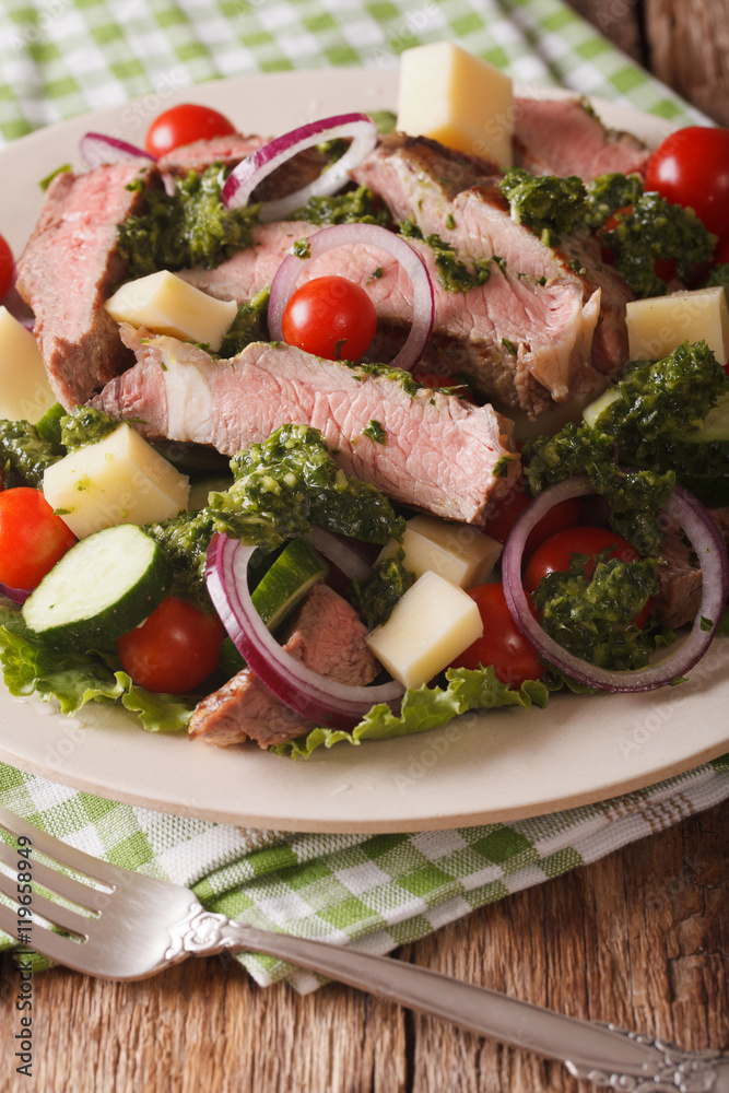 Salad with beef steak, cheese and vegetables dressed with chimichurri sauce closeup. vertical
Salad with beef steak, cheese and vegetables dressed with chimichurri sauce closeup. vertical