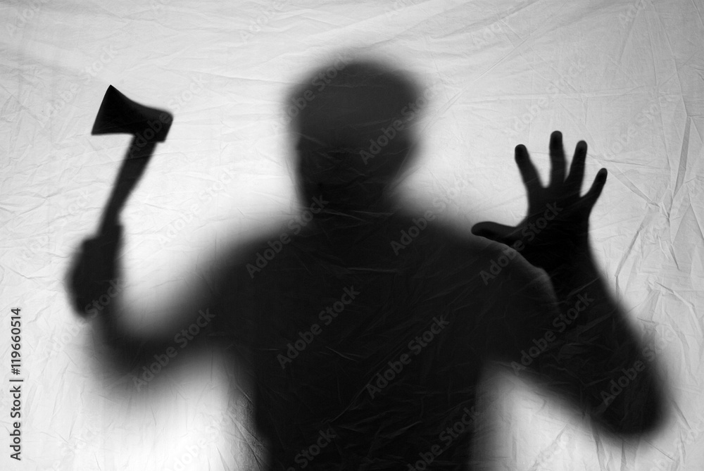 Scary silhouette thick maniac killer with an ax