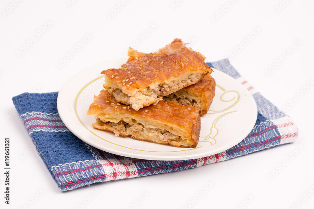 Homemade meat pie on the plate over white background