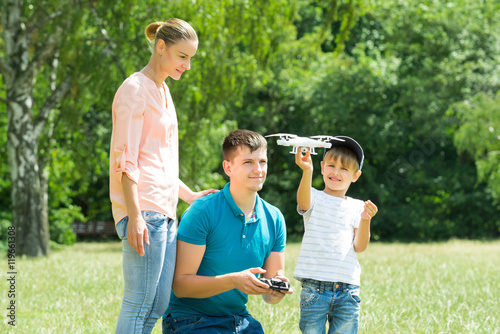Family Flying Drone In The Park