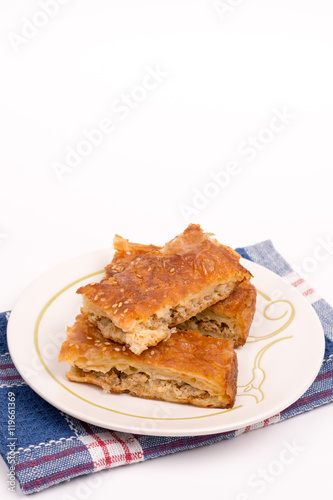 Homemade meat pie on the plate over white background