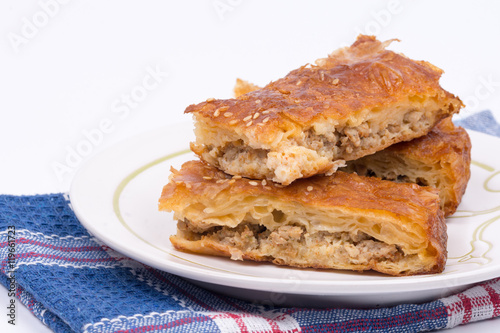 Homemade burek with minced meat over white background