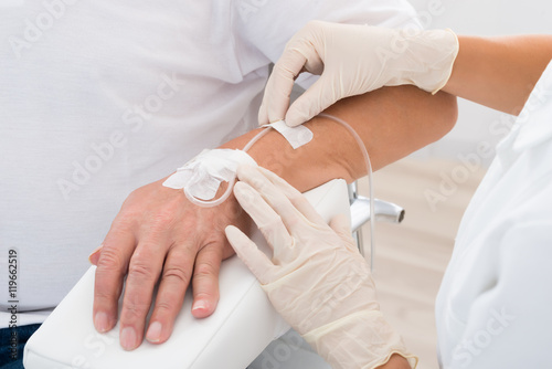 Iv Drip Inserted In Patient's Hand photo