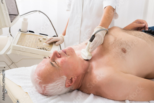 Man Getting Ultrasound Scan On Neck By Doctor
