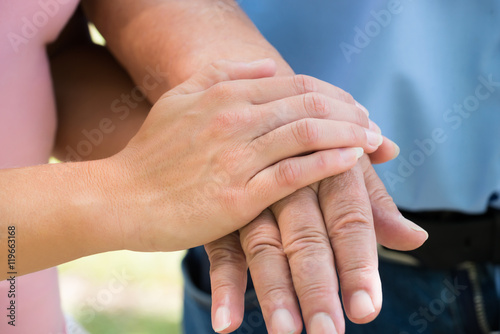 Woman Holding Man's Hand