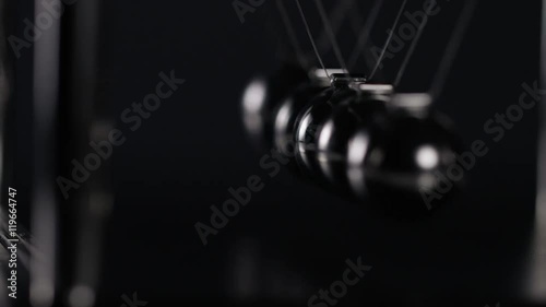 4K Abstract angle of Newton's cradle spheres, in slow motion
