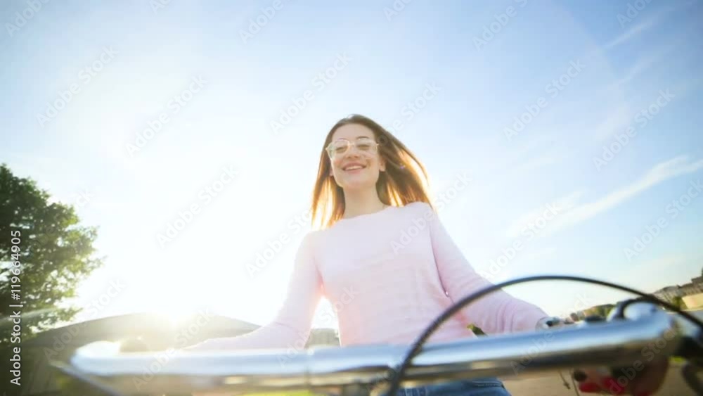 Happy girl Cycling - A lhappygirlcycling under some trees in a park. (camera attached to handlebars),London Happy girl Cycling - A lhappygirlcycling under some trees in a park. (camera attached to handlebars),London