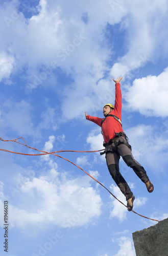 Jump rope from a high rock in the mountains.