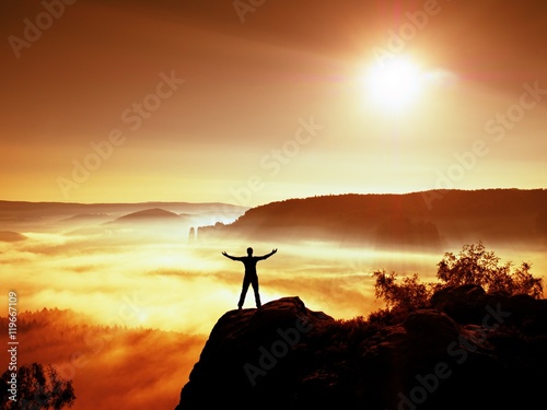 Happy man gesture of triumph with hands in the air. Funny hiker with raised arm
