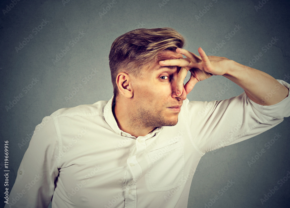 man pinches nose looks with disgust something stinks bad smell man pinches nose looks with disgust something stinks bad smell