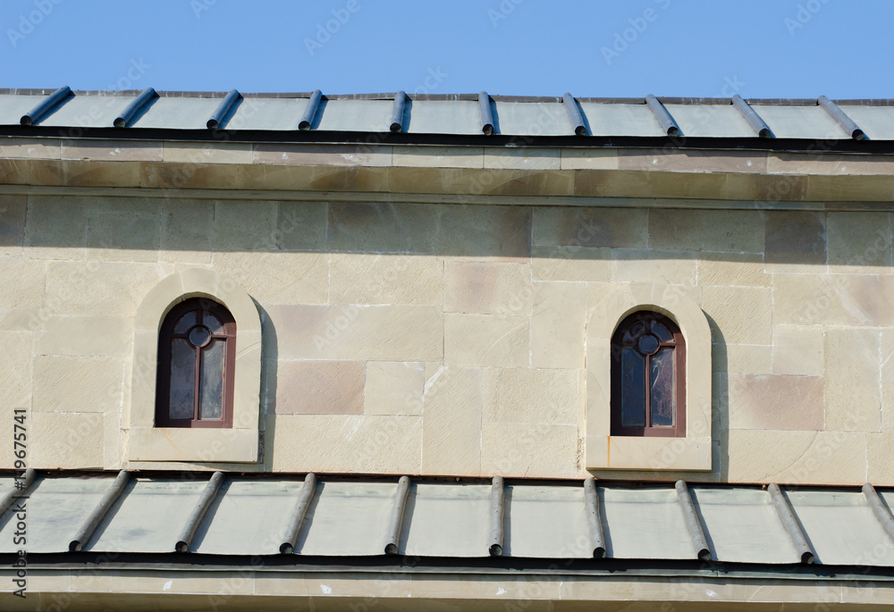 Two small arched windows under the roof Two small arched windows under the roof
